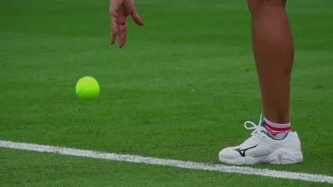 Slow Motion action of a tennis player bouncing the ball before serving Stock Footage 199230055