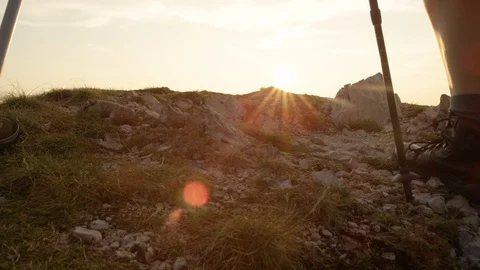SLOW MOTION: Active man and woman in hiking boots walk up to the mountain peak. Stock Footage 116928177