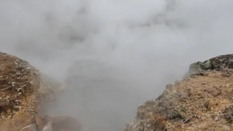 Slow motion activity of an active crater that emits hot steam sulfur Stock Footage 319908833