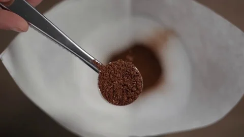 Slow motion Adding ground coffee beans To pour-over coffee machine with Stock Footage 123643515