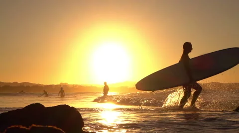 SLOW MOTION: Adventurous young surfer girl running into ocean with surfboard Stock Footage 64890929