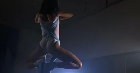 Slow motion aerial acrobatics and artistic gymnastics. A young adult woman spins Stock Footage 277564080
