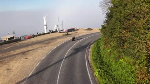 Slow Motion Aerial Approach Toward a Foggy Winding Coastal Road Stock Footage 341806222