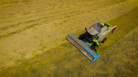 Slow motion aerial drone drift of a combine harvester Stock-Footage 59864637