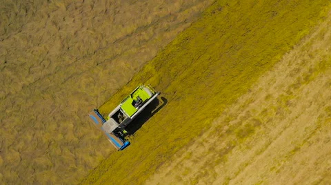Slow motion aerial drone spin of a combine harvester Stock-Footage 59864648