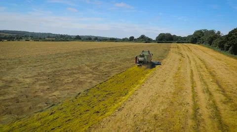 Slow motion aerial drone tracking shot of a combine harvester Stock Footage 59864638