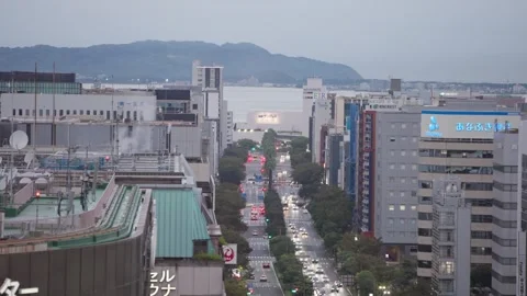 Slow motion aerial perspective of city skyline and harbor in Fukuoka Japan Stock Footage 342811200