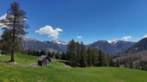 Slow Motion Aerial Push Towards an Old Timber Barn and Forested Alpine S Stock Footage 338270470