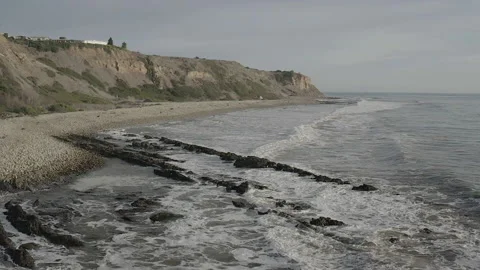 Slow motion aerial pushes over waves towards bluffs of Palos Verdes, CA Stock-Footage 150717009