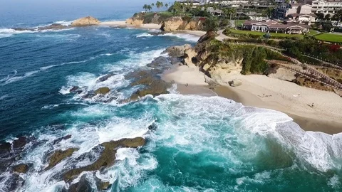 Slow motion aerial of sea waves reaching shore of Laguna beach, California Stock Footage 123736686
