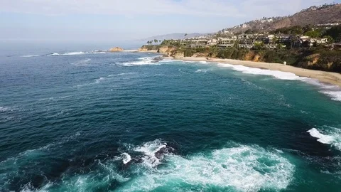 Slow motion aerial of sea waves reaching shore of Laguna beach, California Stock Footage 123736725