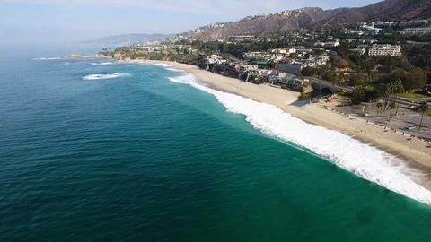 Slow motion aerial of sea waves reaching shore of Laguna beach, California Stock Footage 123736755