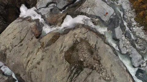 Slow-motion aerial shot of a waterfall. water flowing down on rocks Stock Footage 101001074