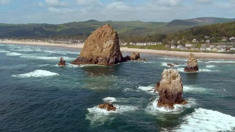 Slow motion aerial shot of waves crashing on Haystack Rock in Cannon Beach. Stock Footage 311582000