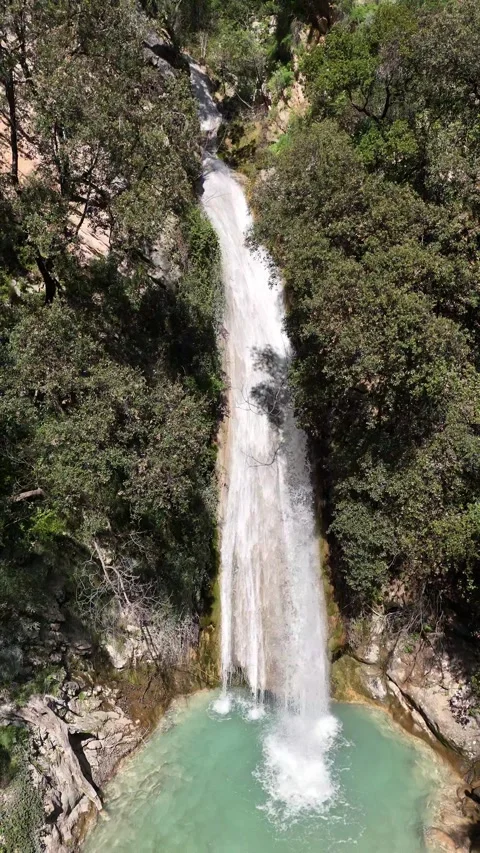 Slow-Motion Aerial vertical View of Neda Waterfall and Emerald Pool Video stock 303997233