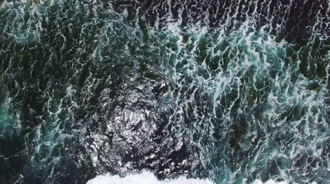Slow motion. Aerial view on the black sand beach. Huge waves on Bali, Indonesia Stock Footage 64754381
