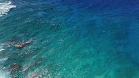 Slow Motion Aerial View of Clear Ocean Water with Reef Below Stock Footage 326014519