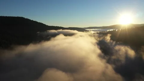 Slow motion aerial view of clouds and mist with sunrise in the morning time Stock Footage 341925257