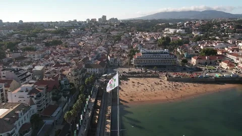 Slow motion aerial view of flag overlooking Cascais Bay ahead of Pope visit Stock Footage 247021504