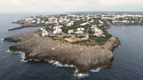 Slow motion aerial view of the fort at the mouth of Cala Llonga, built in 1730 Stock Footage 234885677