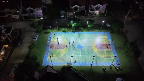Slow Motion Aerial View of Night Basketball Game on Colorful Court Philippin Stock Footage 326849161