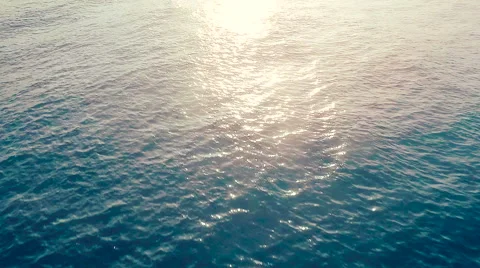 Slow Motion Aerial View over Blue Ocean at Sunrise Stock Footage 56586031