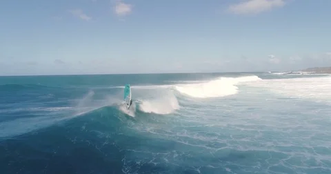 Slow motion aerial view of windsurfer riding giant wave in Hawaii, Extreme Sport Stock Footage 78119135