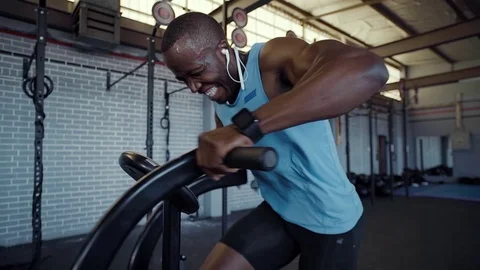 Slow motion of african man working hard on resistance bicycle Stock Footage 71619129