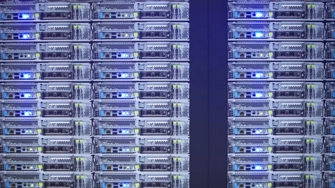 Slow motion of AI server racks blinking with blue LED lights Stock Footage 323215483