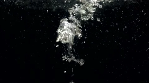 Slow motion air bubbles in water rising up to surface on black background Stock Footage 168467580