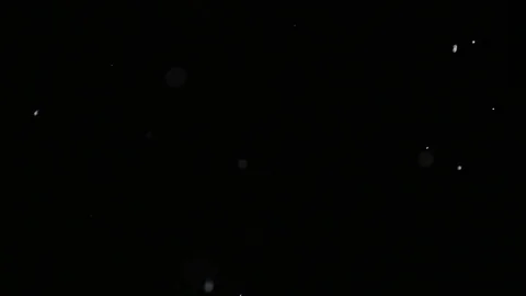 Slow motion air particle practical effect on black Stock Footage 107990941