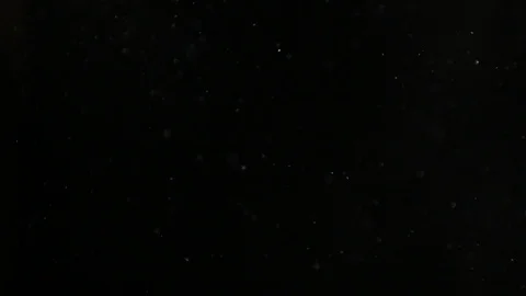 Slow motion air particle practical effect on black Stock Footage 107990947