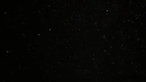 Slow motion air particle practical effect on black Stock Footage 107990962