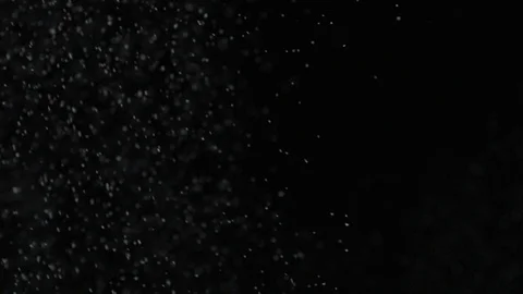 Slow motion air particle practical effect on black Stock Footage 107993604
