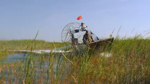 Slow Motion - Airboat crossing through the sawgrass in the everglades Stock Footage