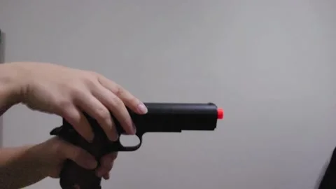Slow Motion Airsoft Pistol Loading and Firing Stock Footage 326703159
