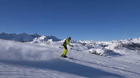 Slow motion - Alpine skier doing swings and speed skiing down the ski slope Stock Footage 84044755