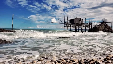 Slow motion - Ancient fishing machine built on the sea rock called Trabocco Stock Footage 215633784
