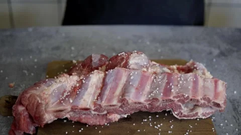 Slow motion and close up of a chef salting meat, beef rib Stock Footage 272282316
