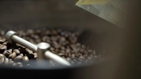 Slow motion and close up of coffee beans being mixed on the mixing shovel Stock Footage 262404036