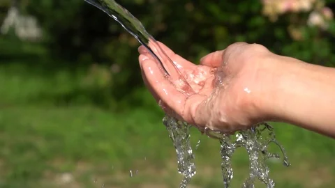 Slow Motion and Close up of Running Water Hitting a Woman's Hand Stock Footage 91670207