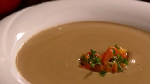 Slow Motion and Close-up On Spinning Round A Plate Of Vegetarian Cream Soup Stock Footage 157101423