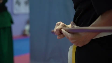 Slow motion and close up of woman's hands practicing tae kwon do wearing yel Stock Footage 142120264