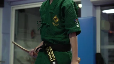 Slow motion and close up of young athlete practicing tae kwon do with swords Video stock 142120040