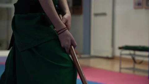 Slow motion and pan of young tae kwon do athlete practicing with sword Stock Footage 142120660