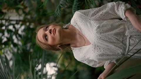 Slow motion and vertical view of the tender woman teenager relaxing in fern Stock Footage 252613750