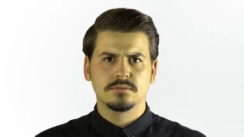 Slow motion angry young man screaming to camera. White background. Vídeo Stock 76203458