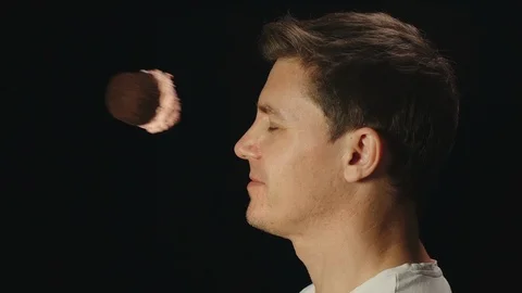 SLOW MOTION: Anyone throw cupcake at man, he smiles and blinks - Side view Stock Footage 96800823