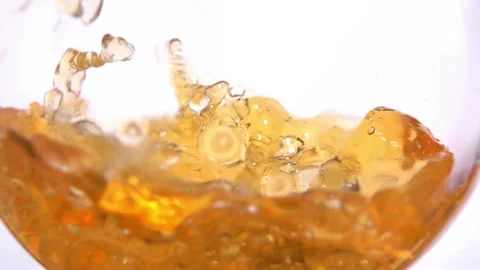 Slow motion an appetizing wave of white grape juice swirls inside the glass Stock Footage 282435073