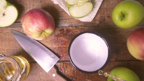 Slow motion of apple juice is poured into a metal cup of top view Stock Footage 72178925